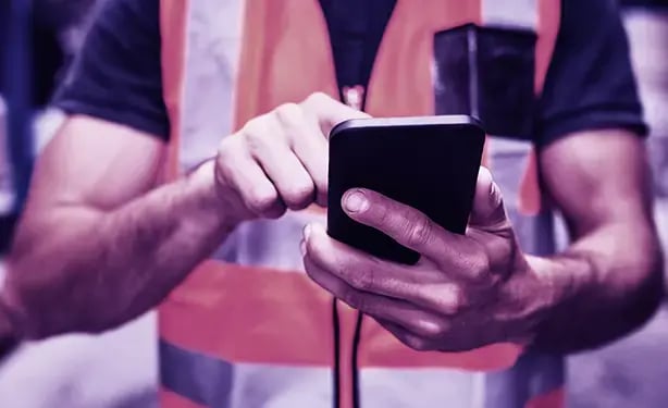 man is using a CMMS on his mobile man is using a CMMS on his mobile